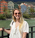 A girl in sunglasses in front of a river in Leinz